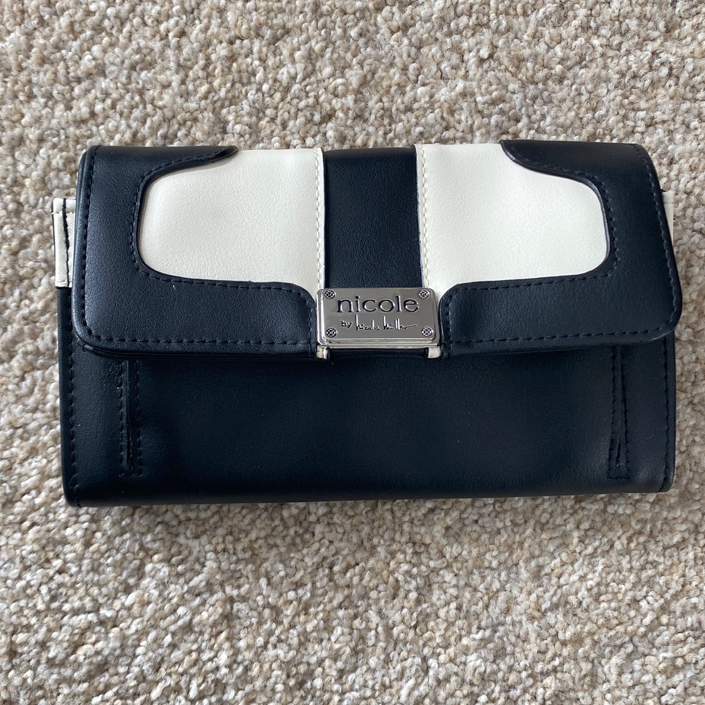 Black and white Nicole Miller wallet. Pink inside